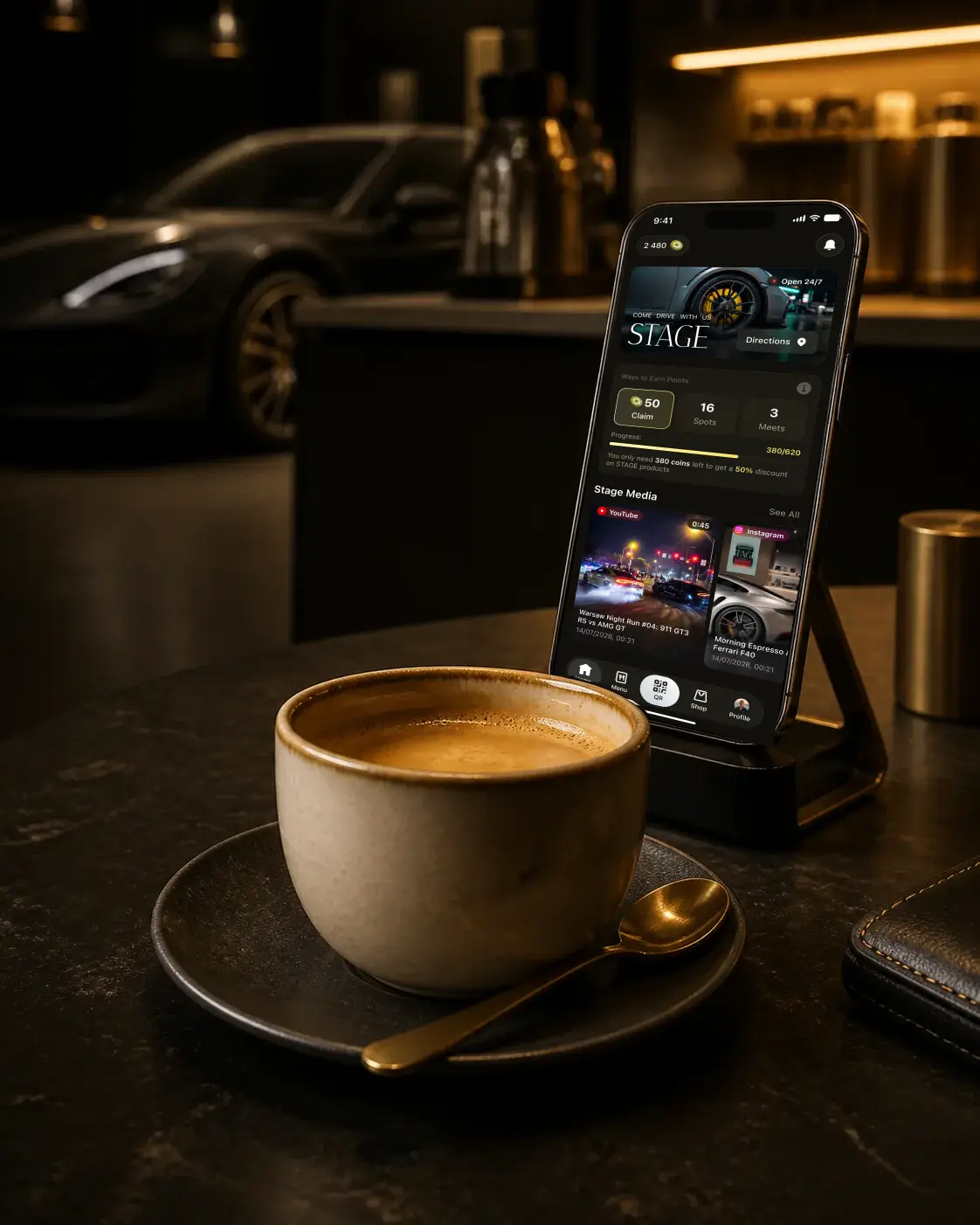 Concept visual of the STAGE loyalty app beside coffee in an automotive-themed cafe